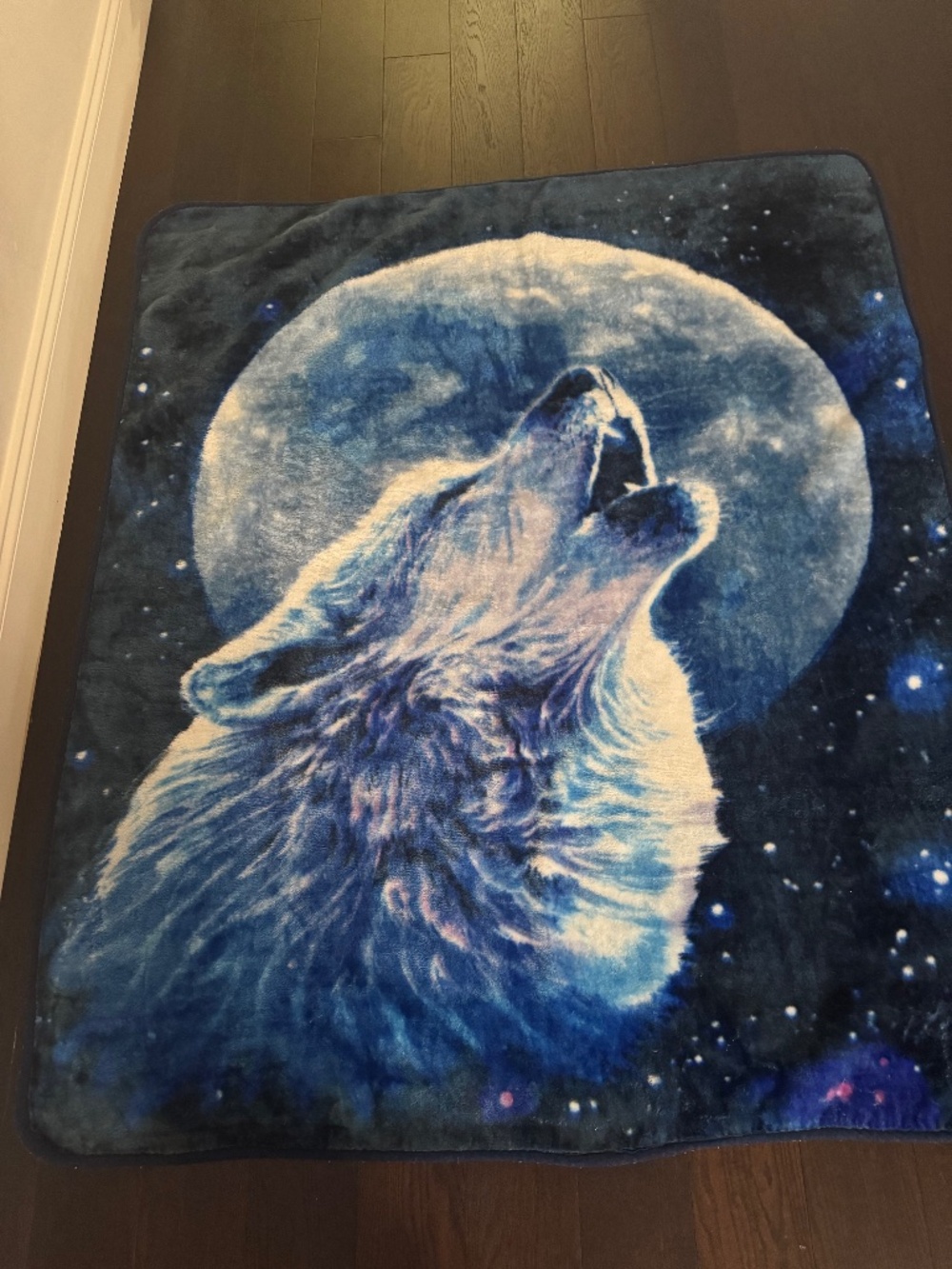 Howling Wolf Full Moon Fleece Throw Blanket featuring a majestic wolf howling at